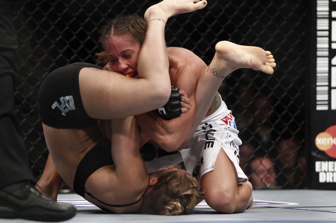 Ronda Rousey postures for an armbar on Liz Carmouche during UFC 157 on Sat....