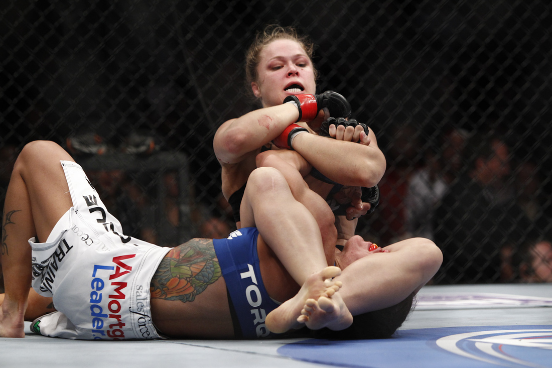 Ronda Rousey completes the armbar of Liz Carmouche during UFC 157 on Sat., ...