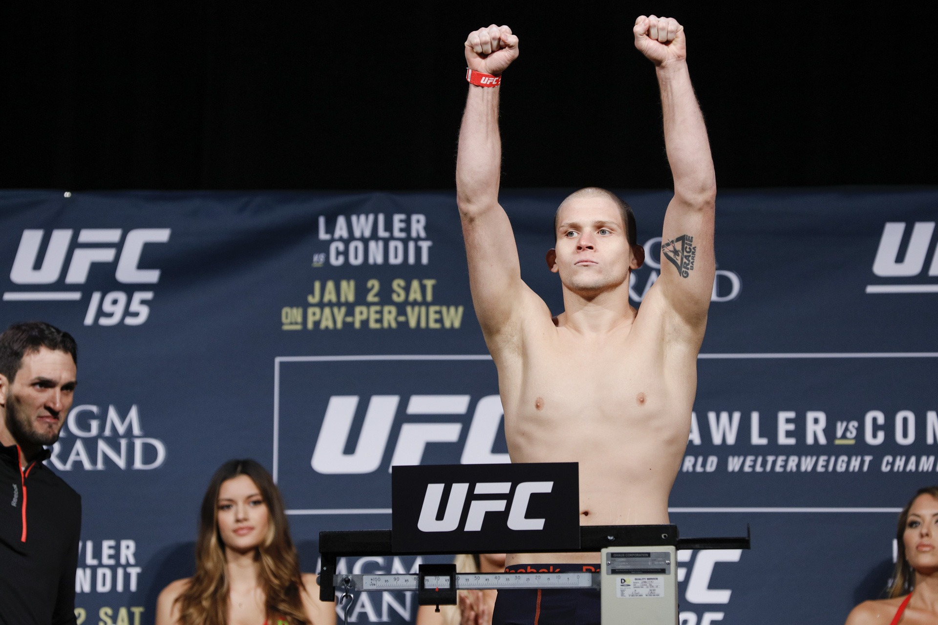 Alex Morono raises his arms during the UFC 195 weigh-ins at the MGM Grand G...