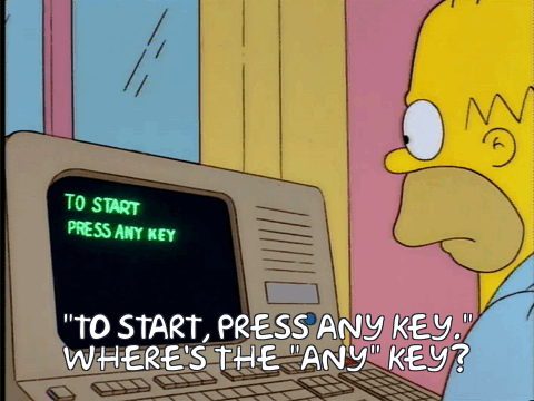 Homer Simpson tries to find the Any key