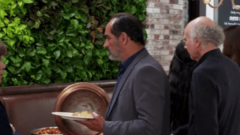 GIF of Larry serving a man seconds at brunch