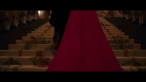 GIF of someone attempting to steal a necklace from Anne Hathaway’s neck