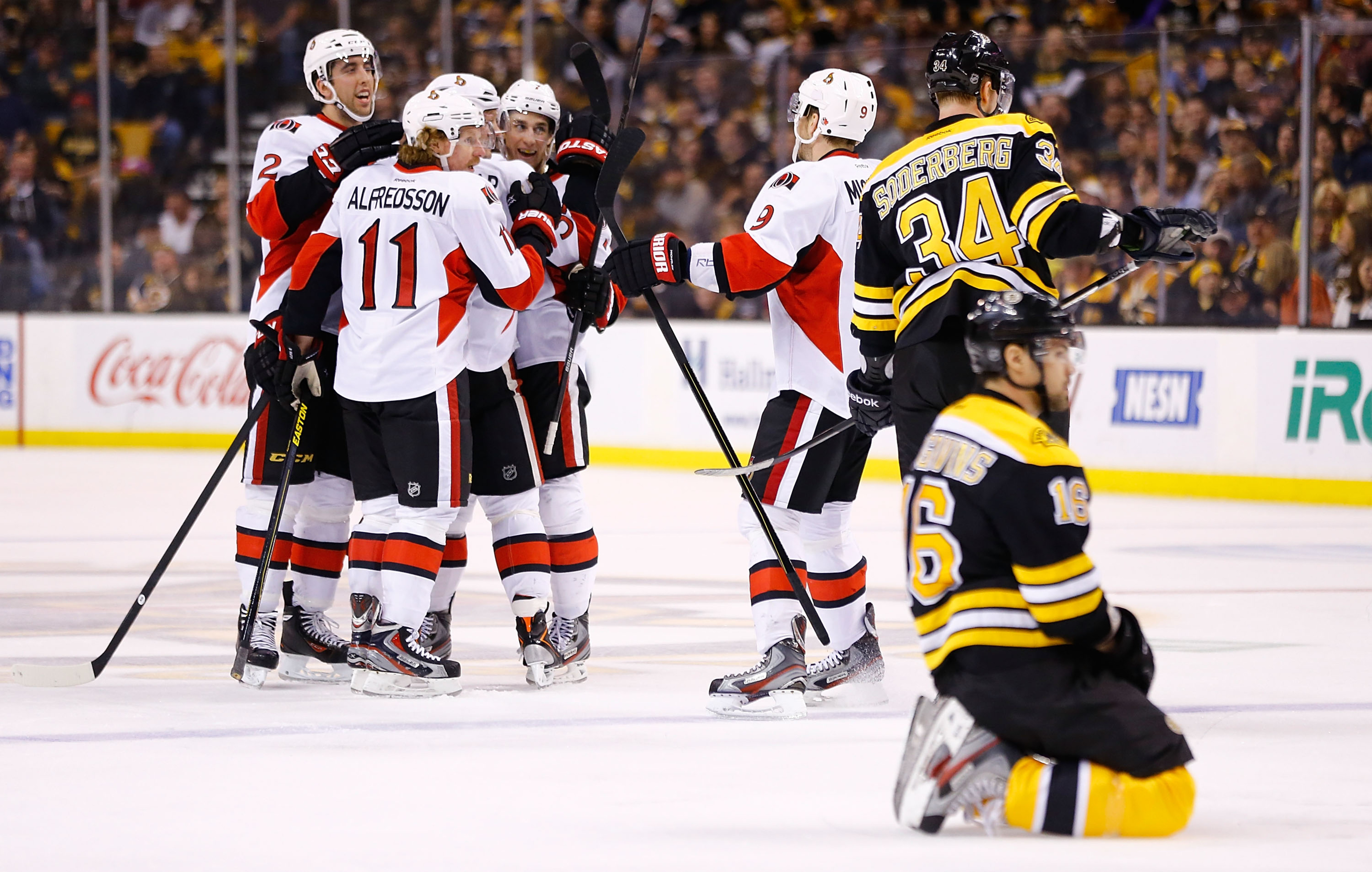Kaspars Daugavins rests on his haunches in the foreground as the Senators celebrate Jared Cowen's second period goal.