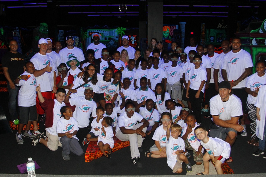 Miami Dolphins players and MDWO members with students from Henry S. Reeves Elementary at Monster Mini Golf in Miramar