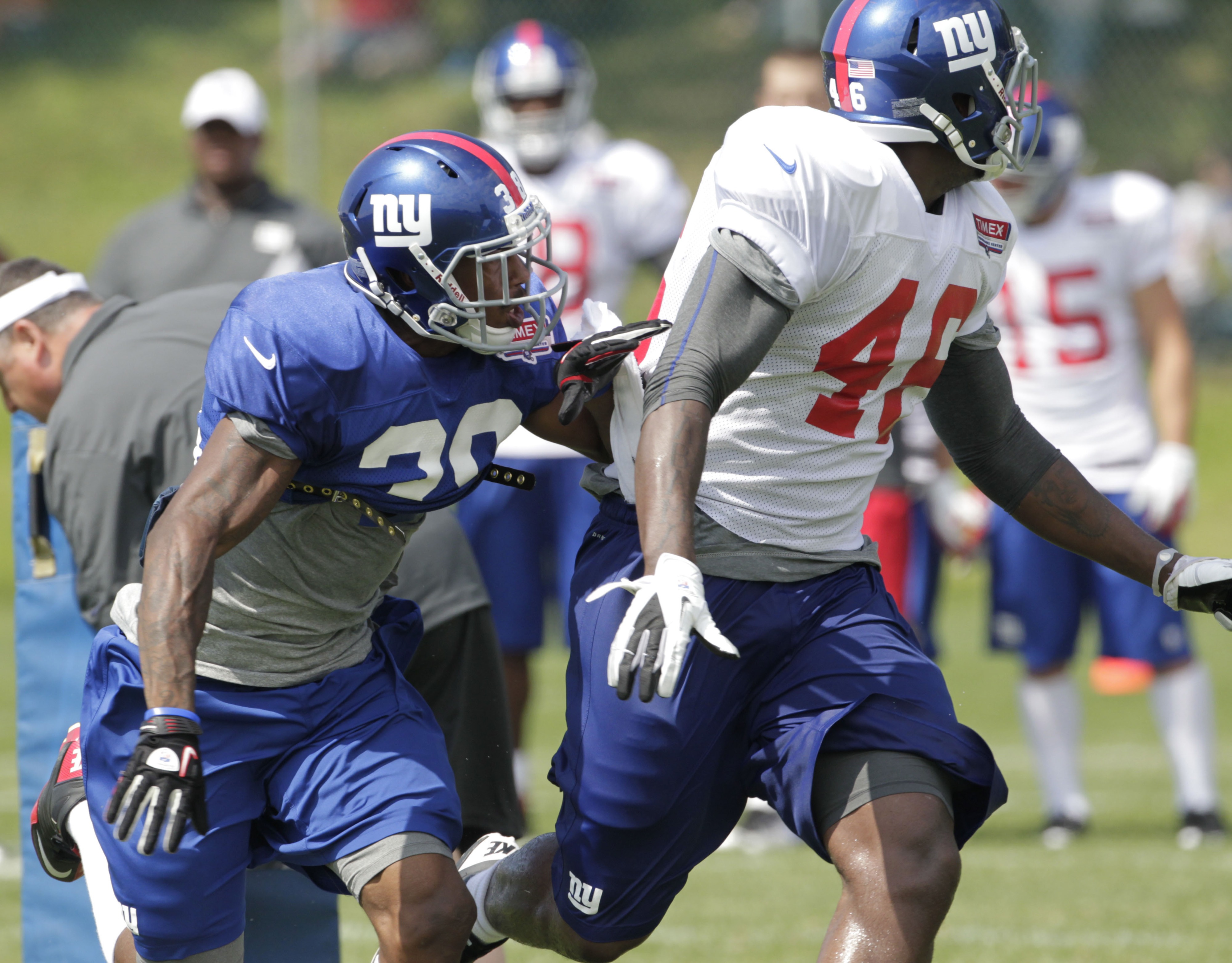 Larry Donnell (white jersey) runs a route during 2012 training camp