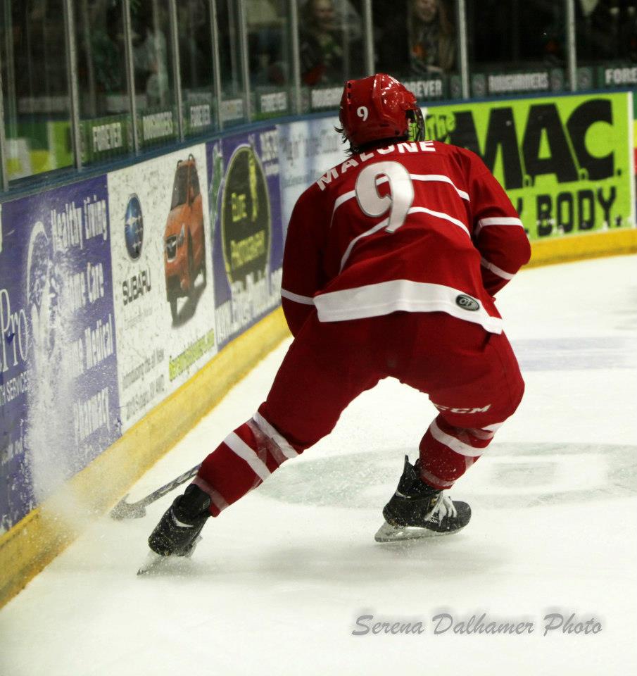 Seamus Malone plays the puck behind the net in a USHL game last season.