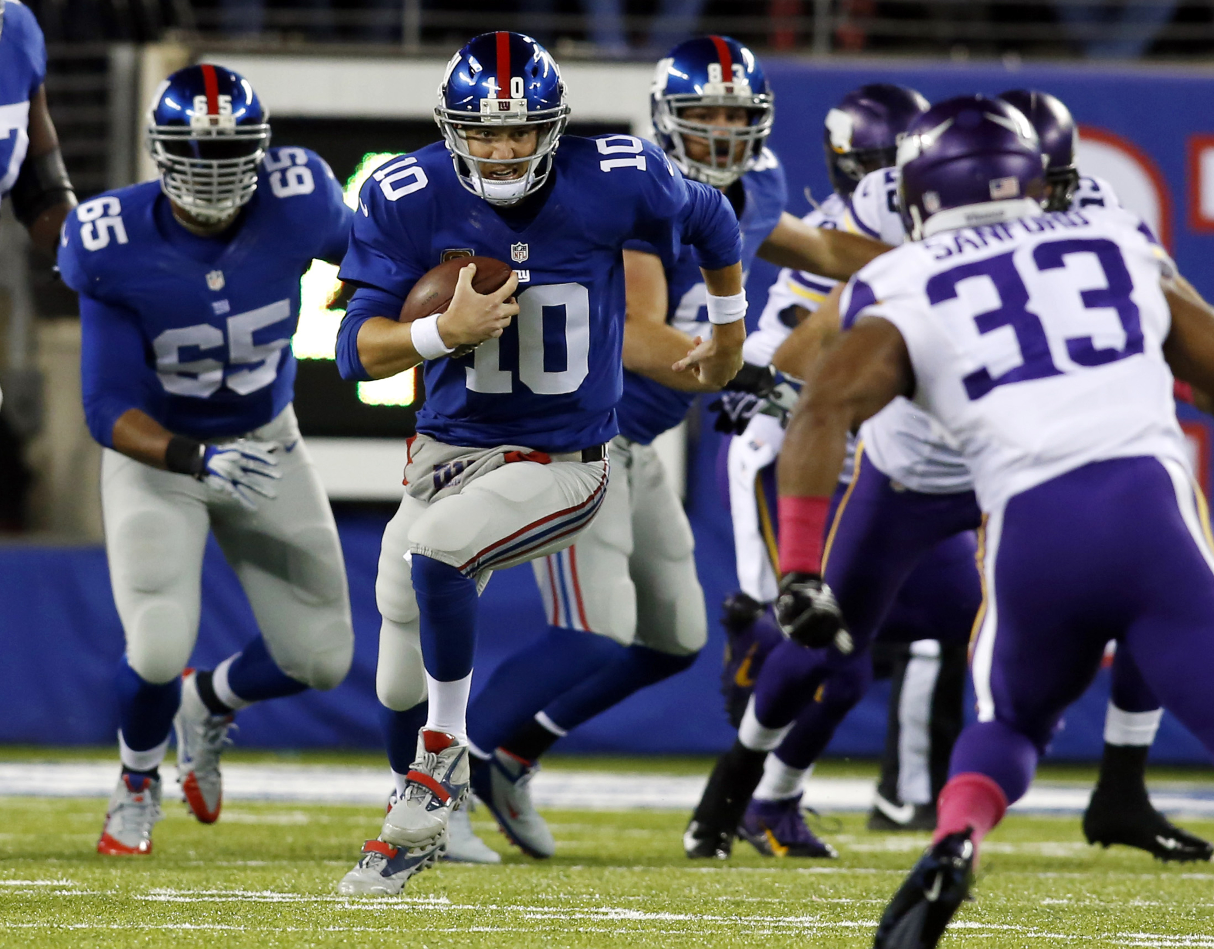 Eli Manning runs for a first down in the first quarter Monday night.