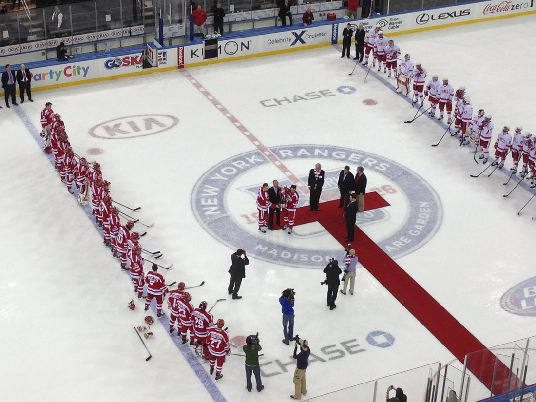 Cornell and BU players stand at the blue line at Madison Square Garden for Red Hot Hockey.