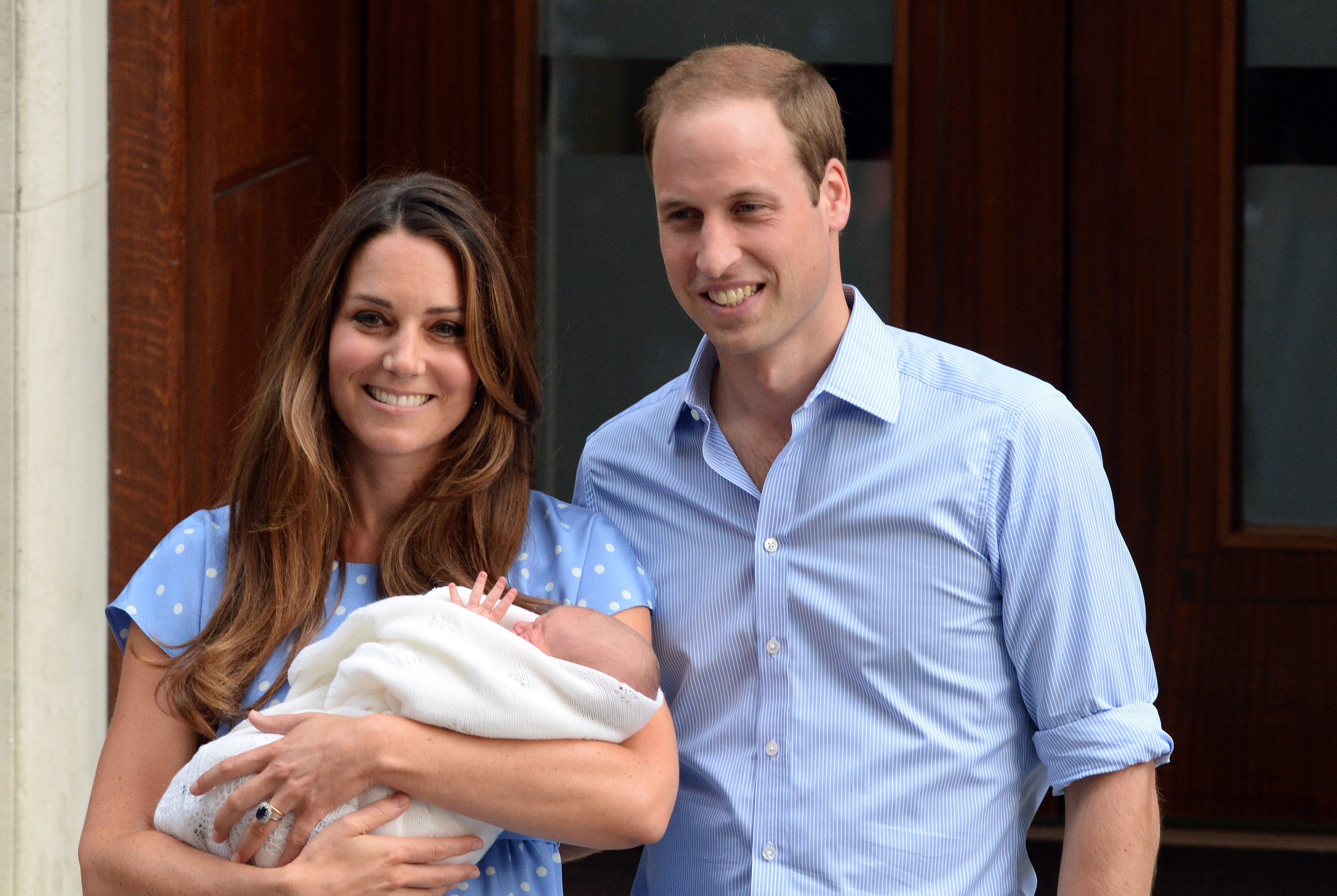 Kate Middleton and Prince William pose with baby George in 2013. 
