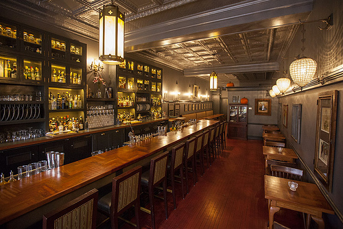 A narrow, brightly-lit bar space