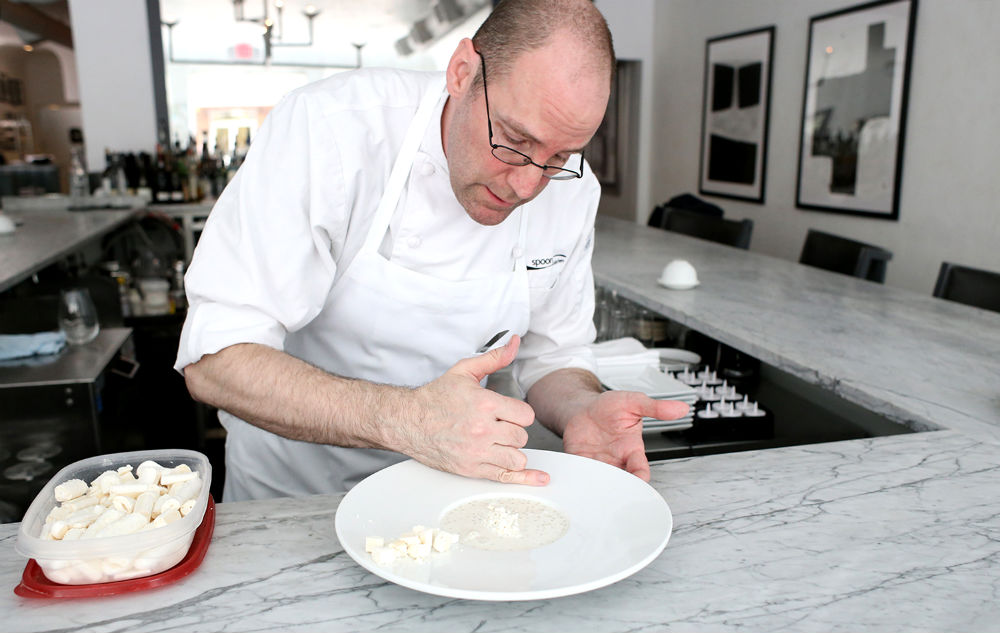 Pastry chef David Collier plates a dessert at Spoon. 