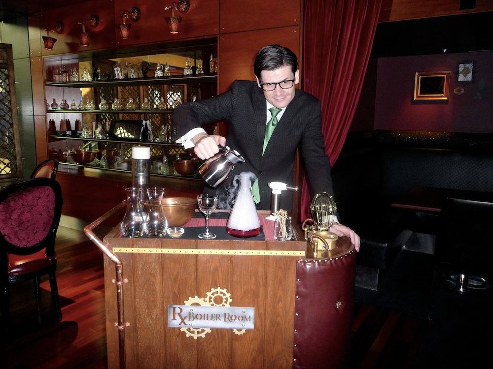  Eric Smith conjures up a concoction on the Rx Boiler Room cocktail cart. 