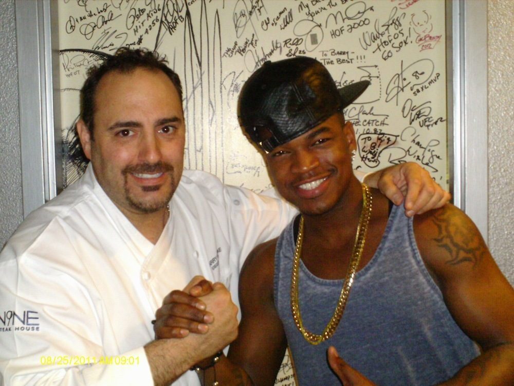 Ne-Yo and executive chef Barry Dakake pose in front of the celebrity Shake Down Door at N9NE Steakhouse.