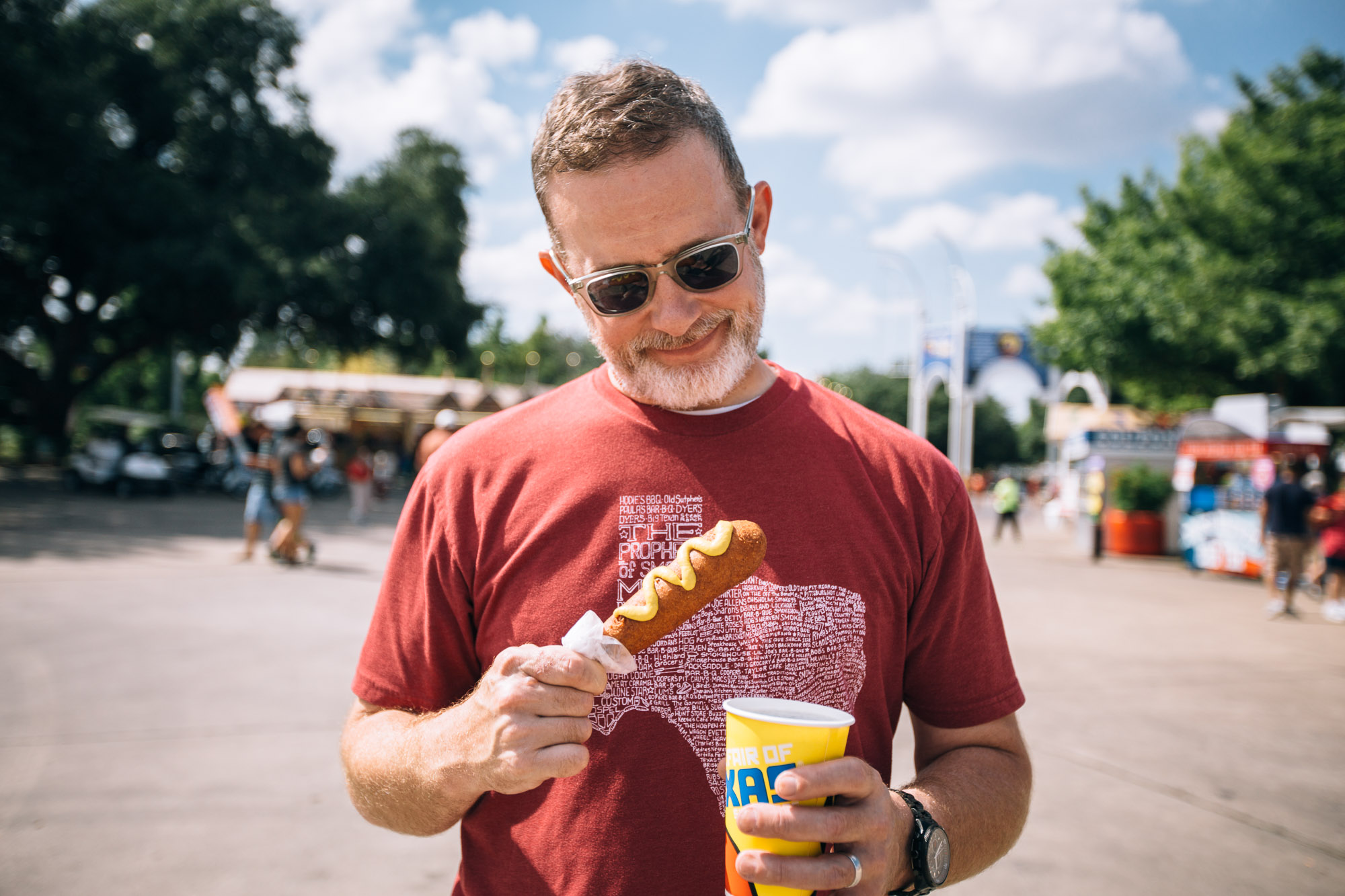 a person stares pensively at a corn dog