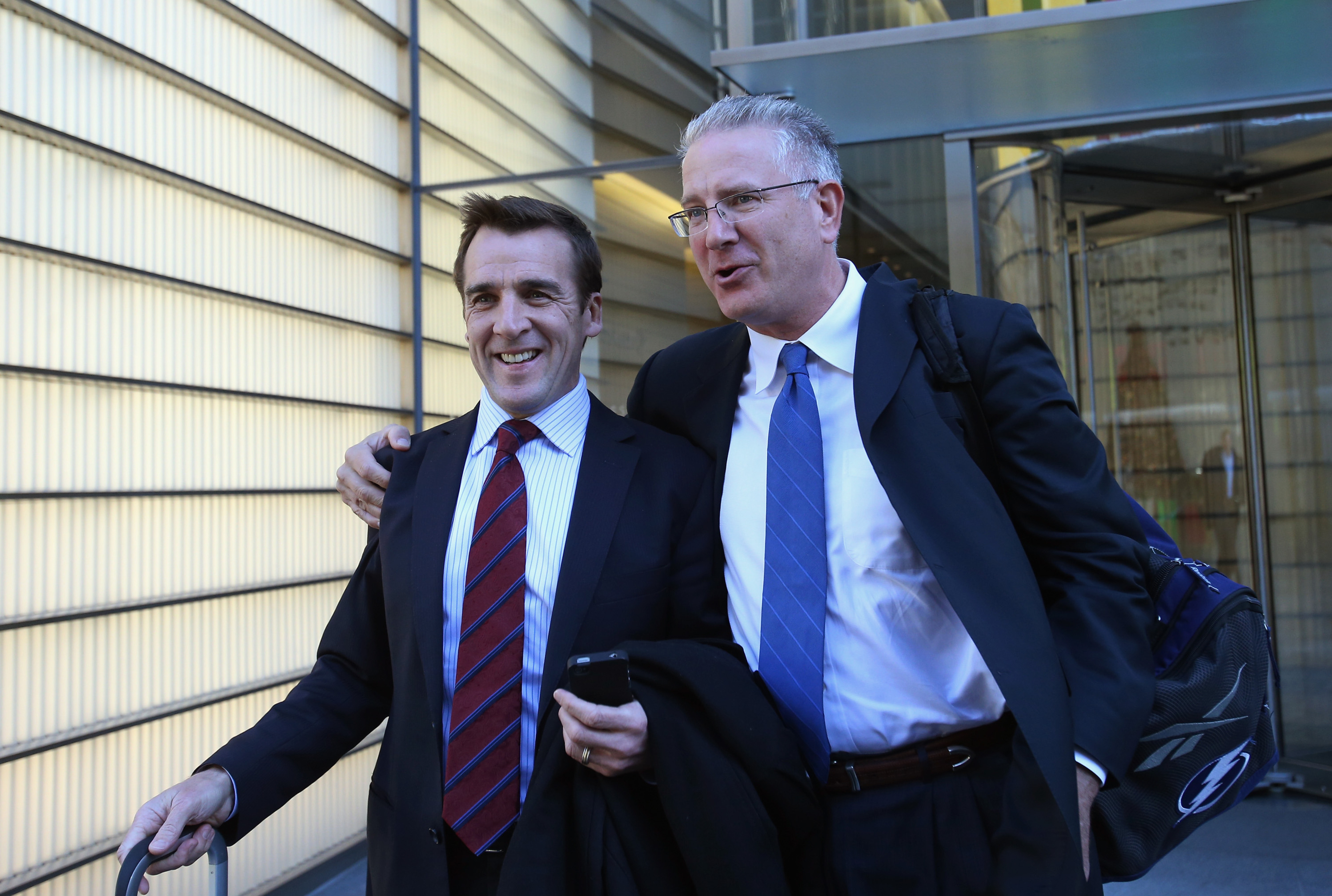 Capitals General Manager George McPhee (left) leaves Wednesday's NHL Board of Governors meeting in New York alongside Lightning CEO Tod Leiweke