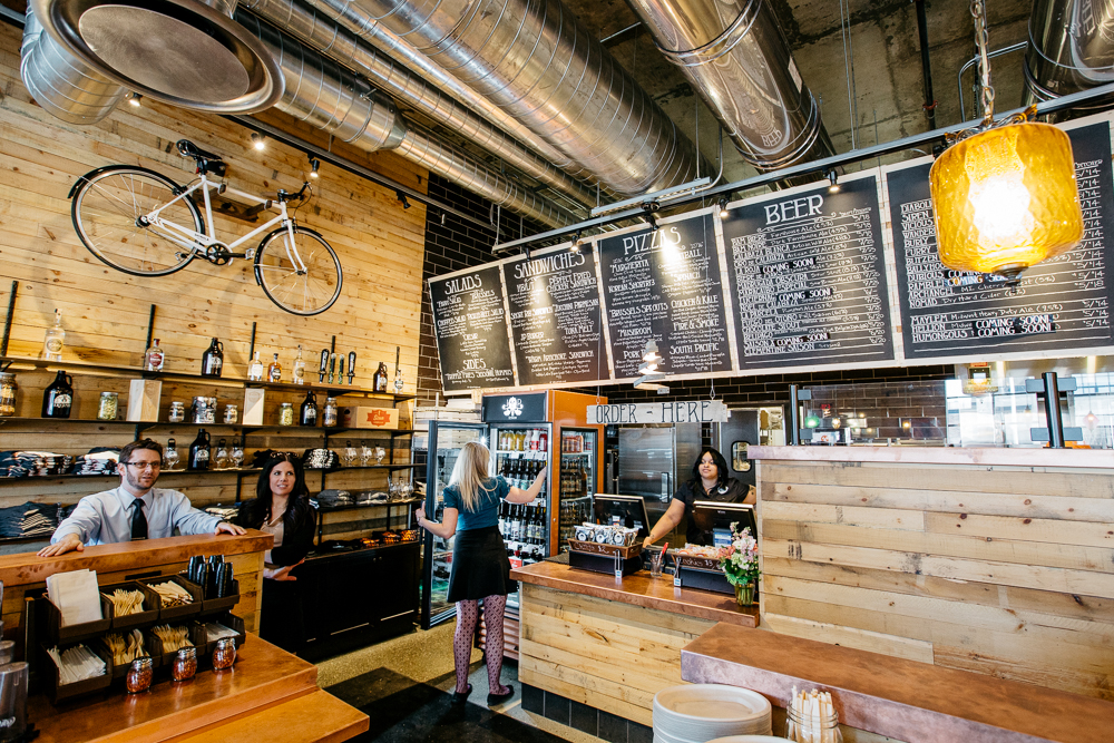 A bicycle hangs on the wood-paneled wall at Jolly Pumpkin next to the line for placing orders. 