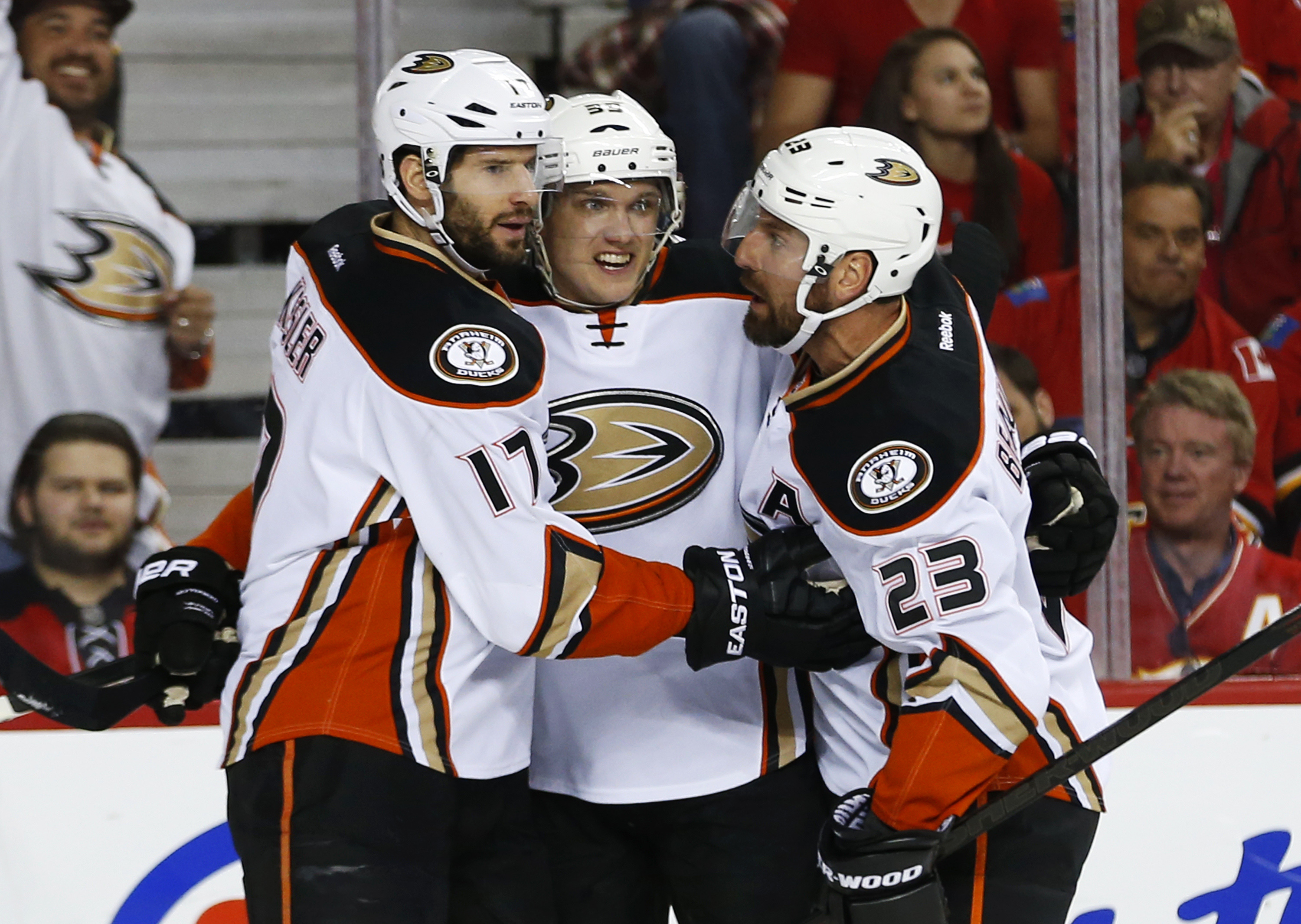 Jakob Silfverberg celebrates with Ryan Kesler and Francois Beauchemin after his first period power play goal.