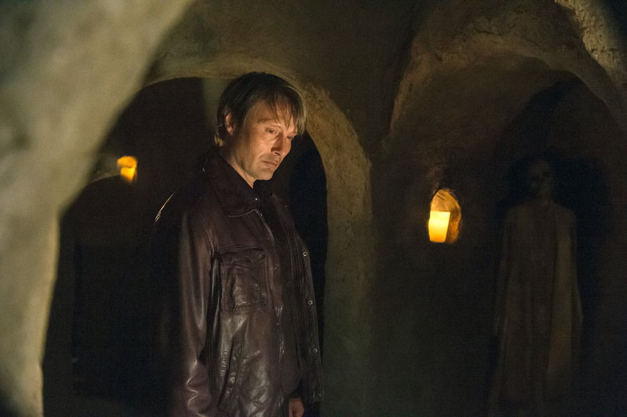 Hannibal Lecter (Mads Mikkelsen) slips into the catacombs in a scene from Hannibal's new season. 