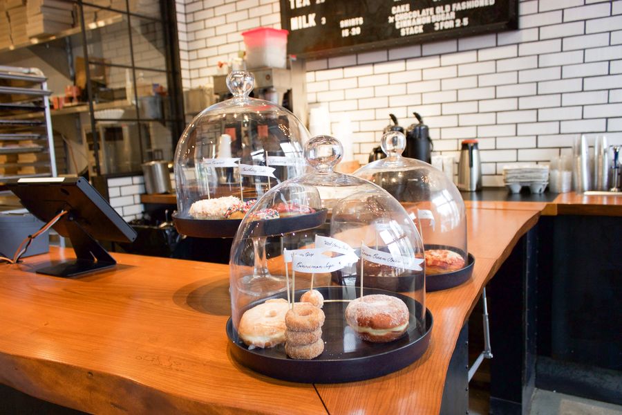 Three display cases showcase a variety of doughnuts at the original South End location of Blackbird Doughnuts