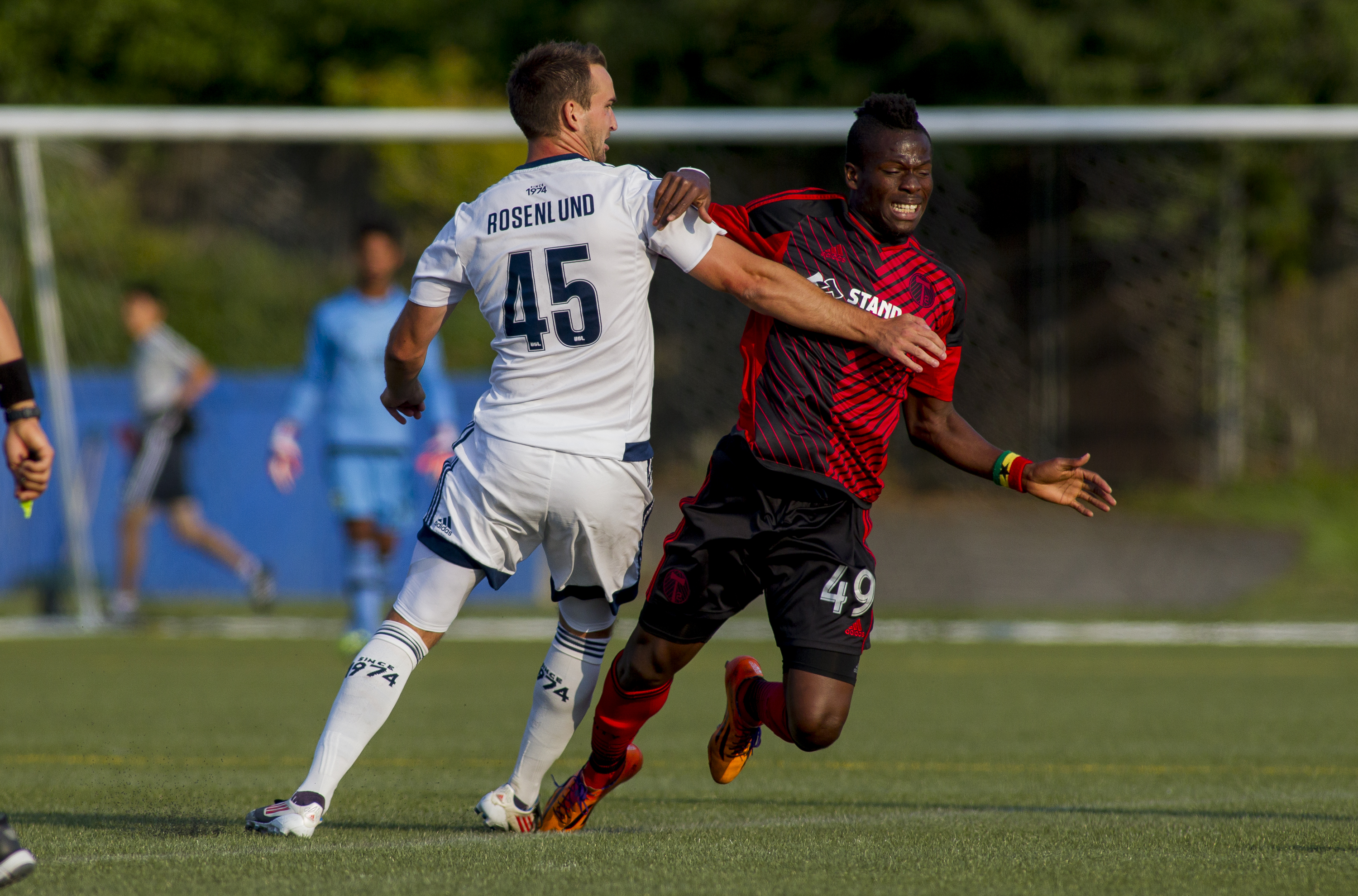 Port Coquitlam's Tyler Rosenlund (L) battles with Portland's Fatawu Safiu during a match on July 10th, 2015 at UBC Thunderbird Stadium.  WFC2 defeated T2 by a score of 2-1.