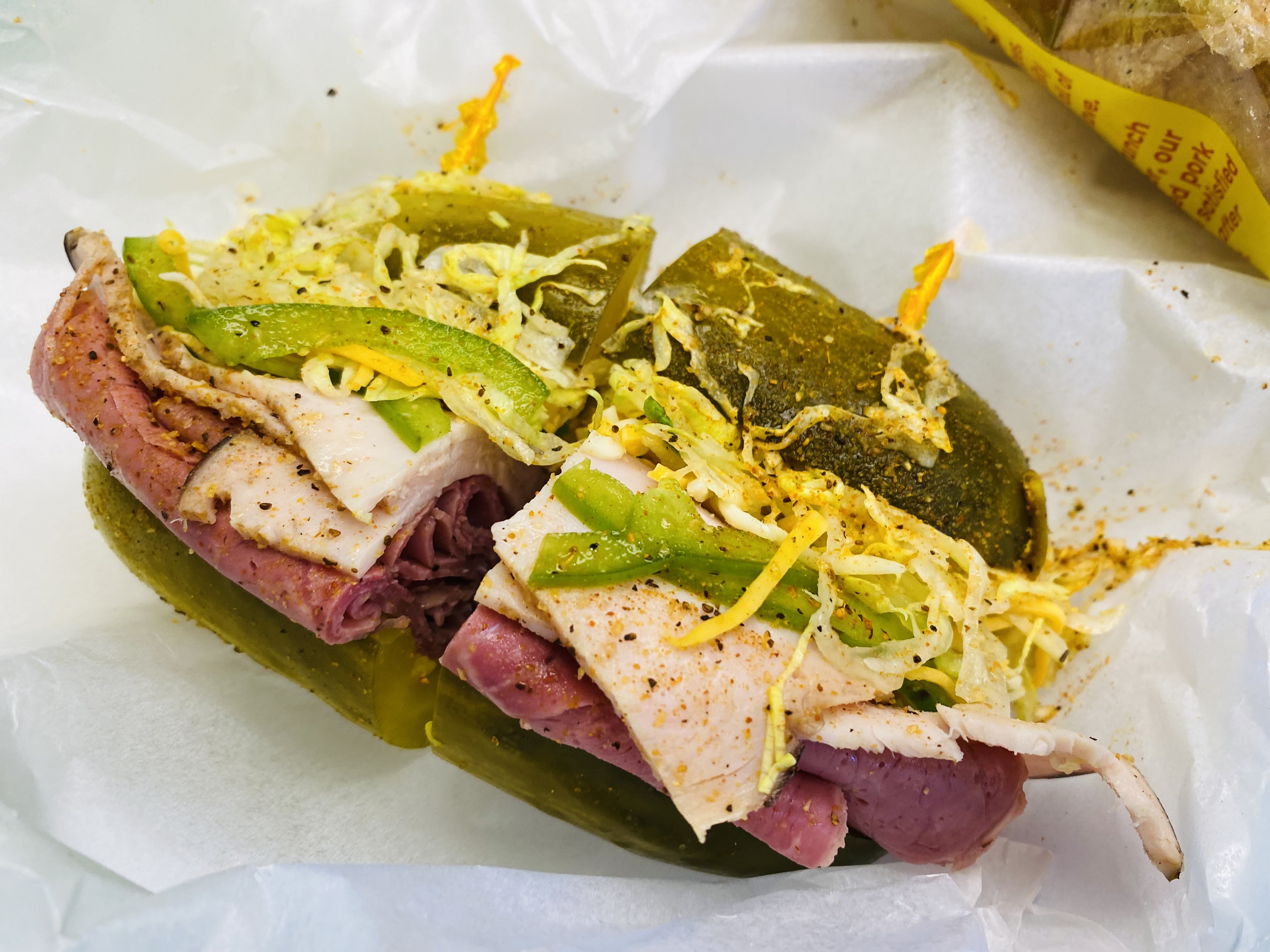The What’s the Dill sandwich is filled with corned beef, turkey, cheese, bell peppers, lettuce, sweet and spicy mustard, and seasonings at What’s the Dill deli in Detroit, Michigan.