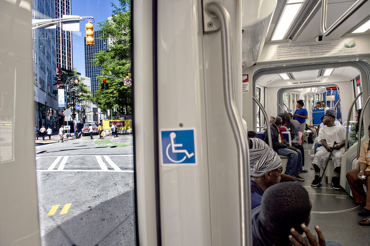 [An Atlanta Streetcar filled with passengers makes the turn towards the Hurt Park stop in downtown. Photos: Jonathan Phillips, Curbed Atlanta] 
