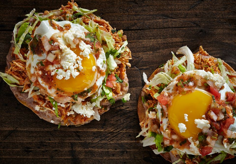 Two tostadas with a runny egg in the middle.