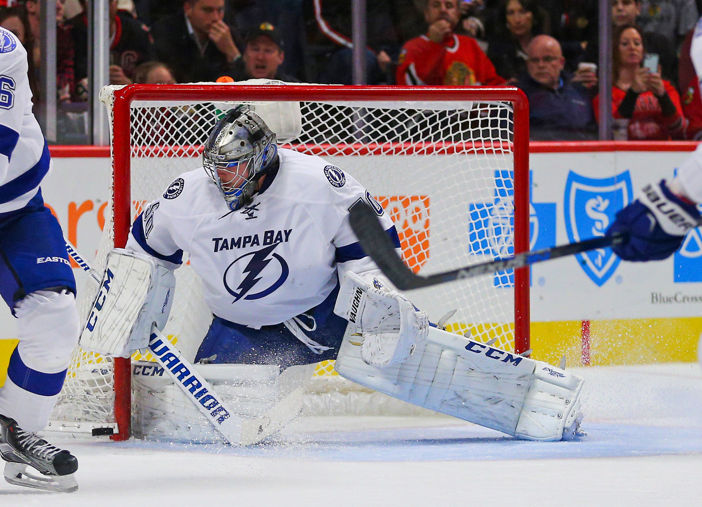 Tampa Bay Lightning Goaltender Kristers Gudlevskis looks for a loose puck in a game against the Chicago Blackhawks.