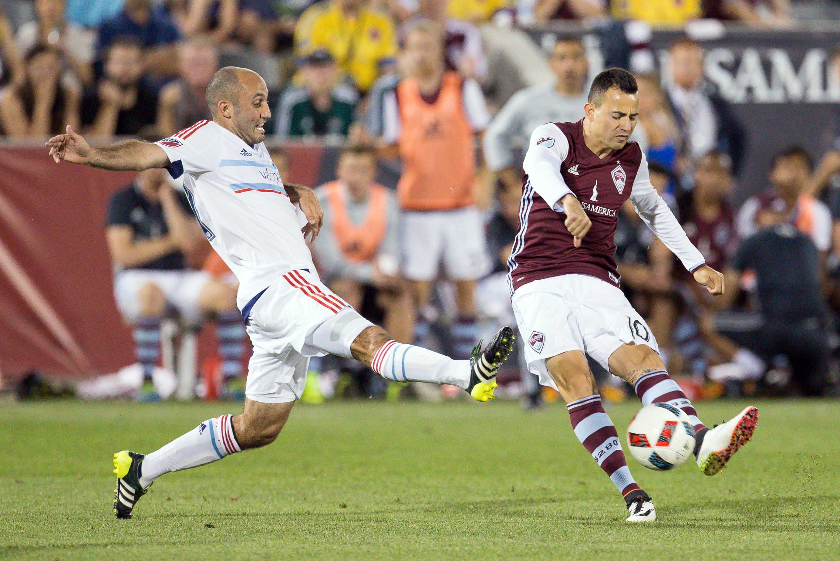 Marco Pappa taking a shot against former Rapids player Nick LaBrocca.