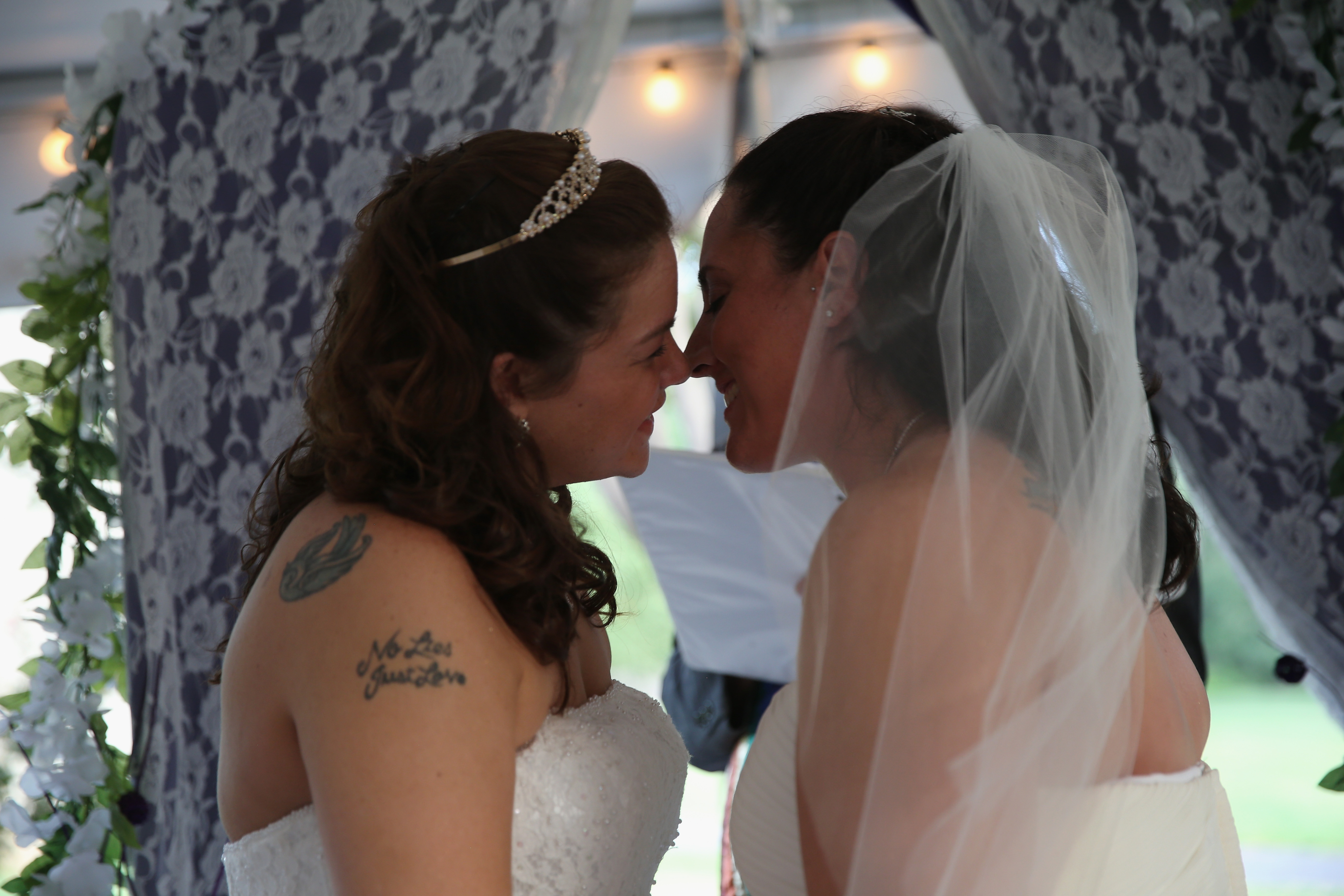 two brides kissing