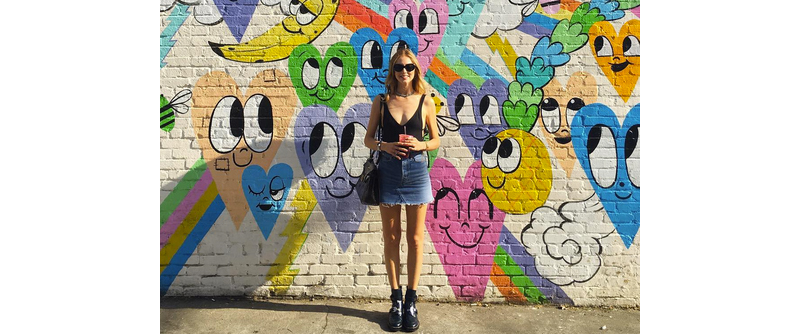 blogger Chiara Ferragni standing in front of colorful mural