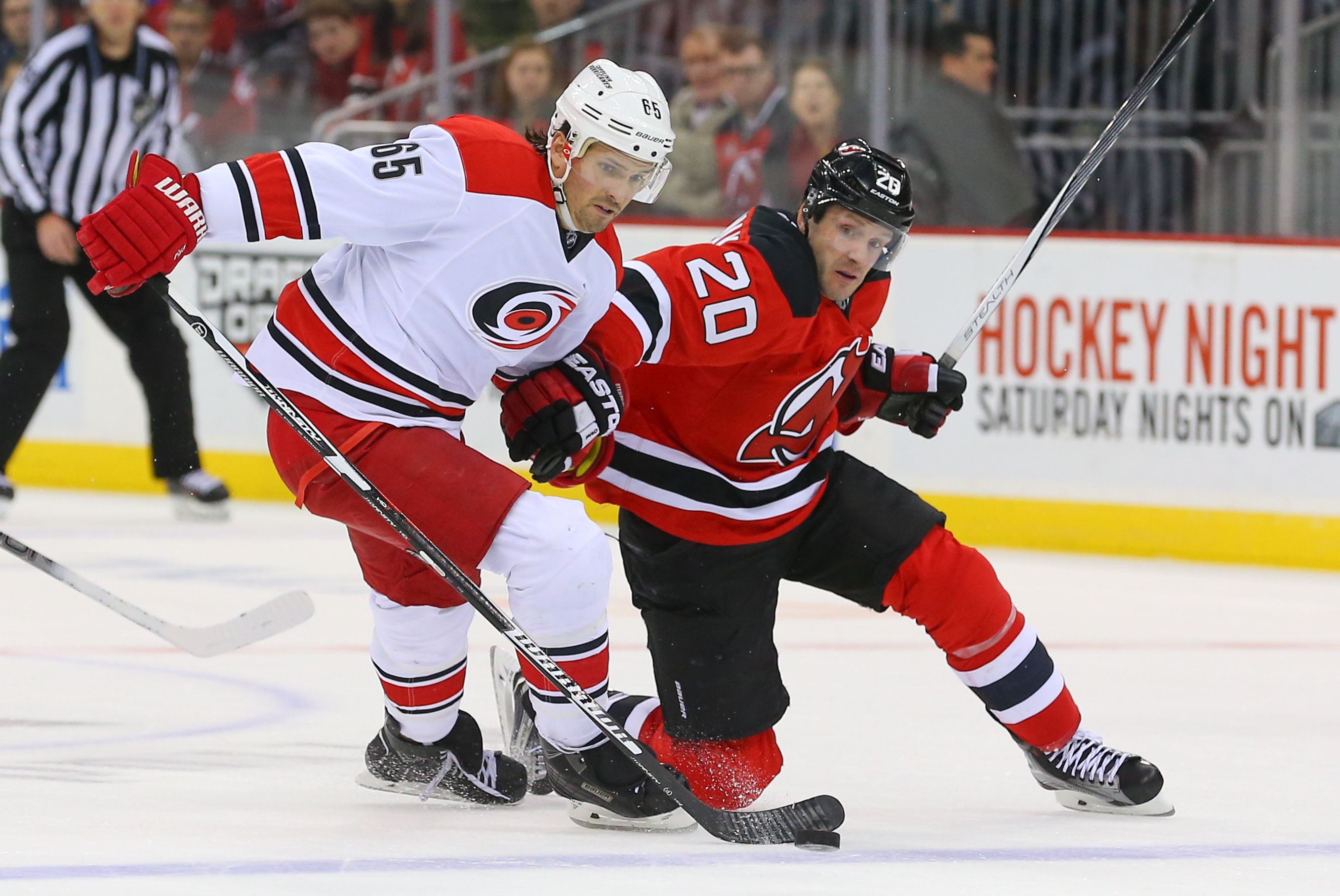 Lee Stempniak battles with Ron Hainsey in NHL action