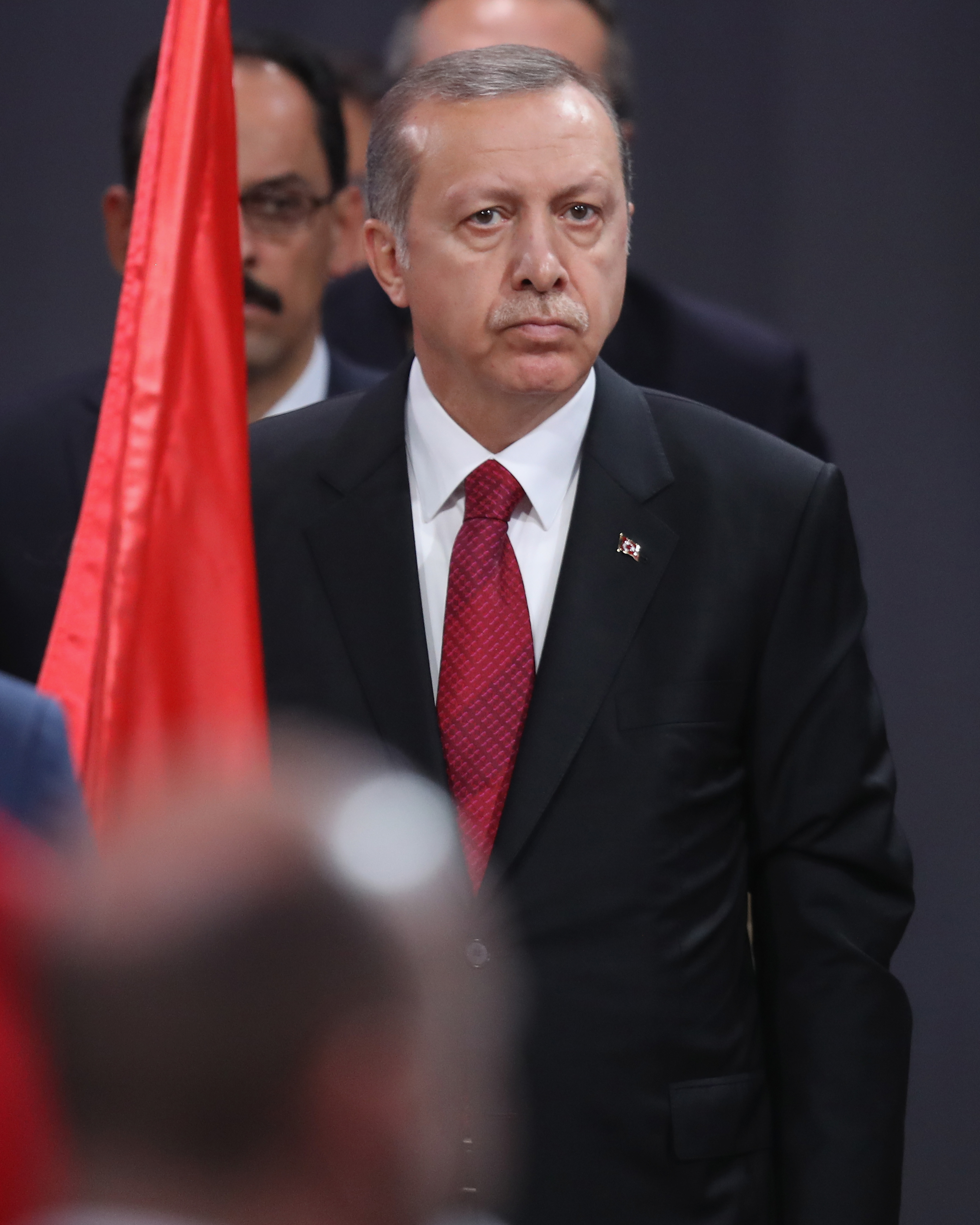Turkish President Recep Tayyip Erdogan observes a ceremony to honor NATO soldiers killed in the line of duty.