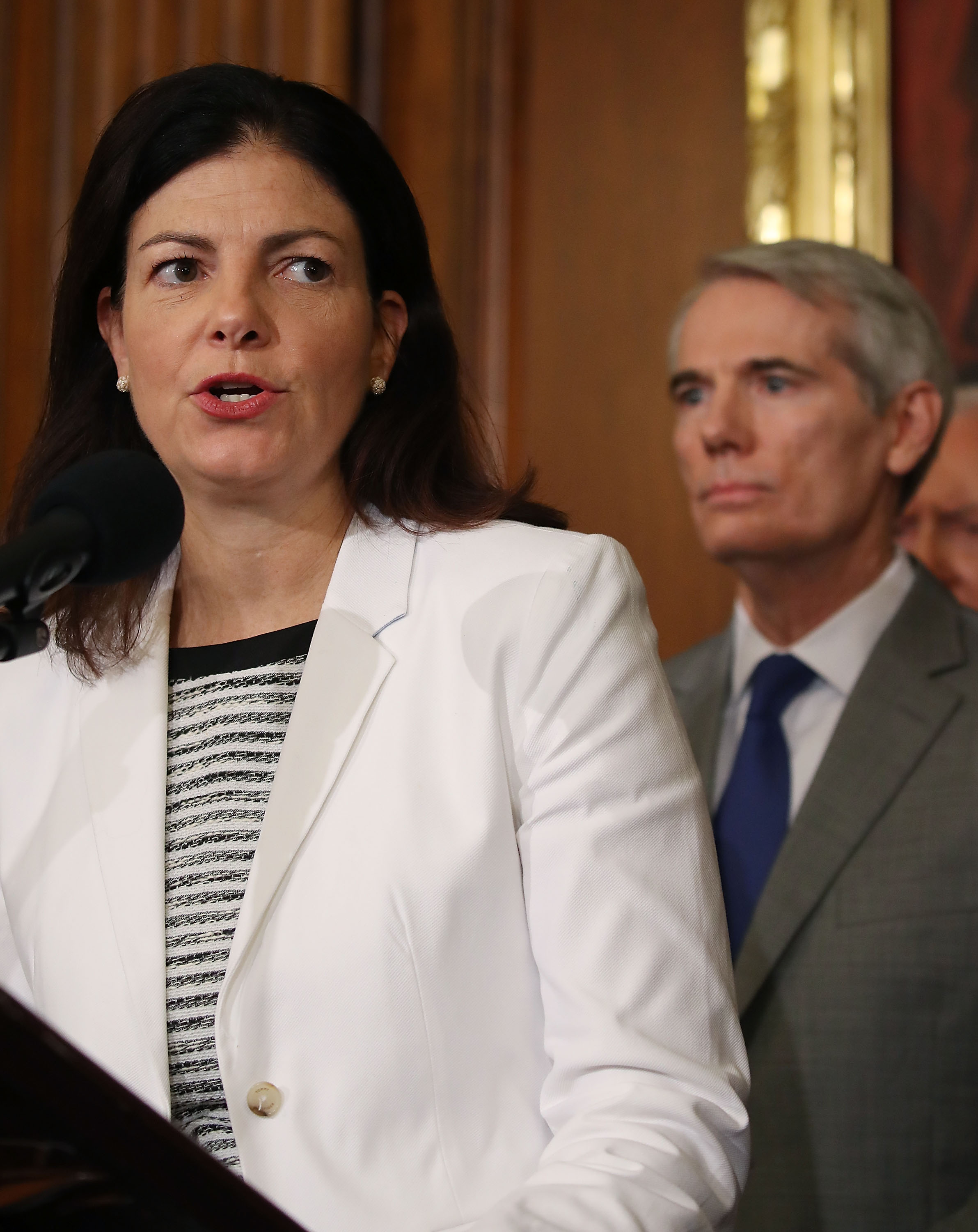 Sen. Kelly Ayotte (R-NH) speaks while flanked by Sen. Rob Portman (R-OH).