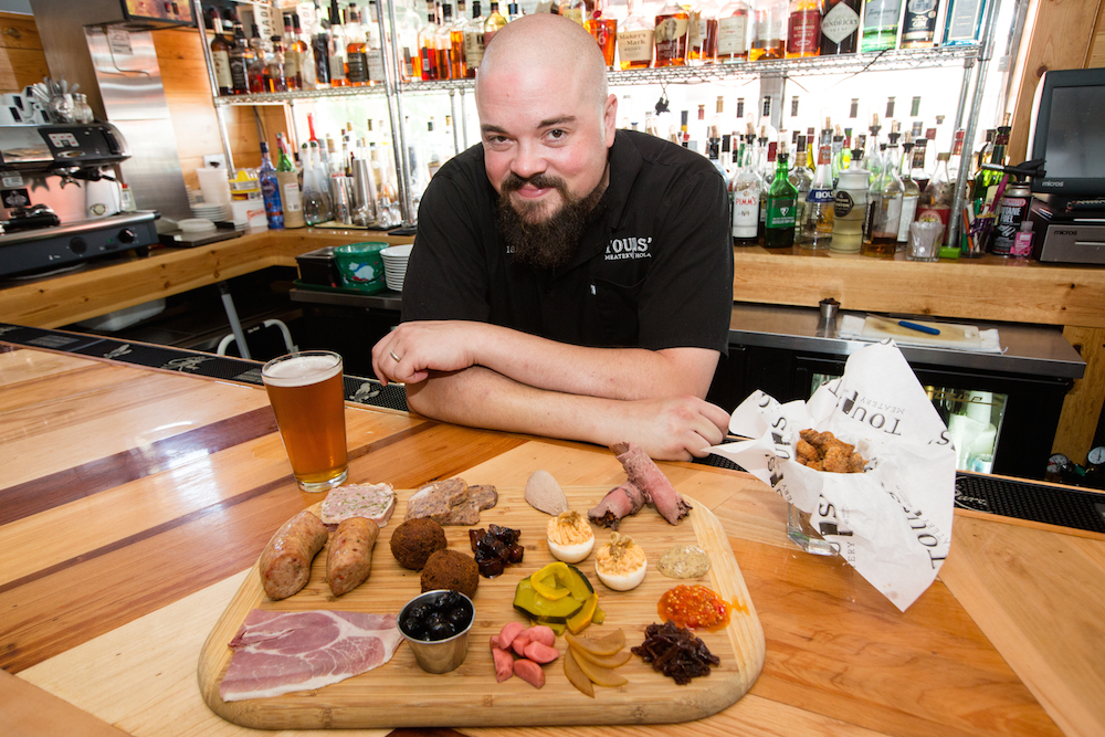 Chef Isaac Toups with his meatery board