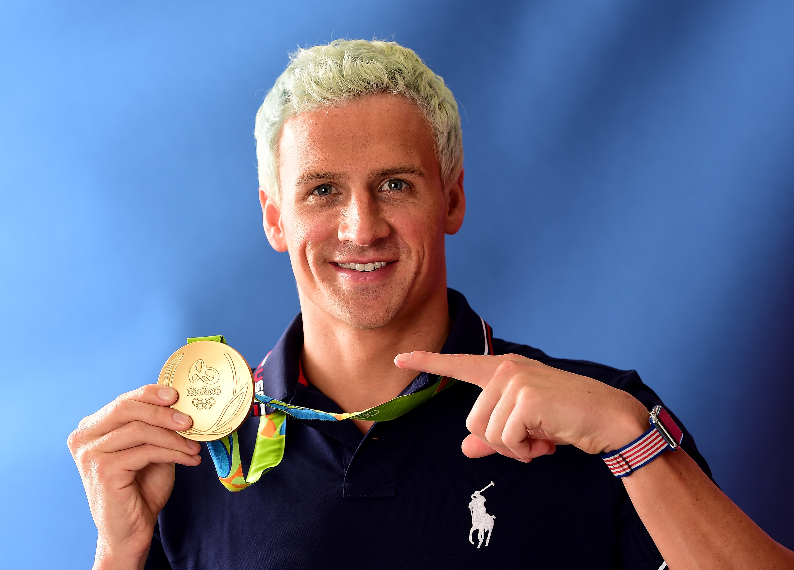 Swimmer Ryan Lochte of the United States poses for a photo with his gold medal on the Today show set on Copacabana Beach on August 12, 2016, in Rio de Janeiro.