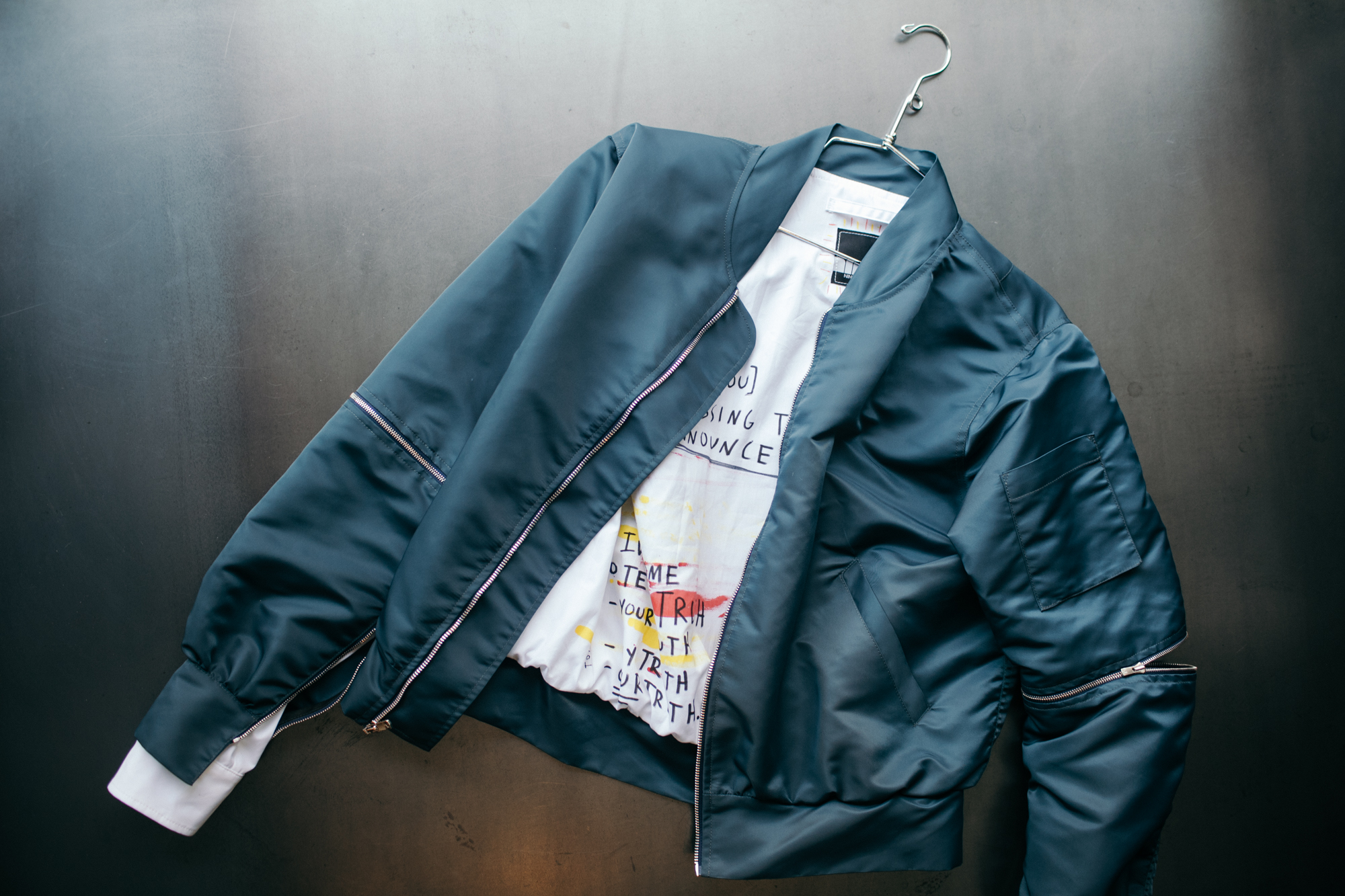 A bomber jacket with sleeves that zip off and a painted liner. 