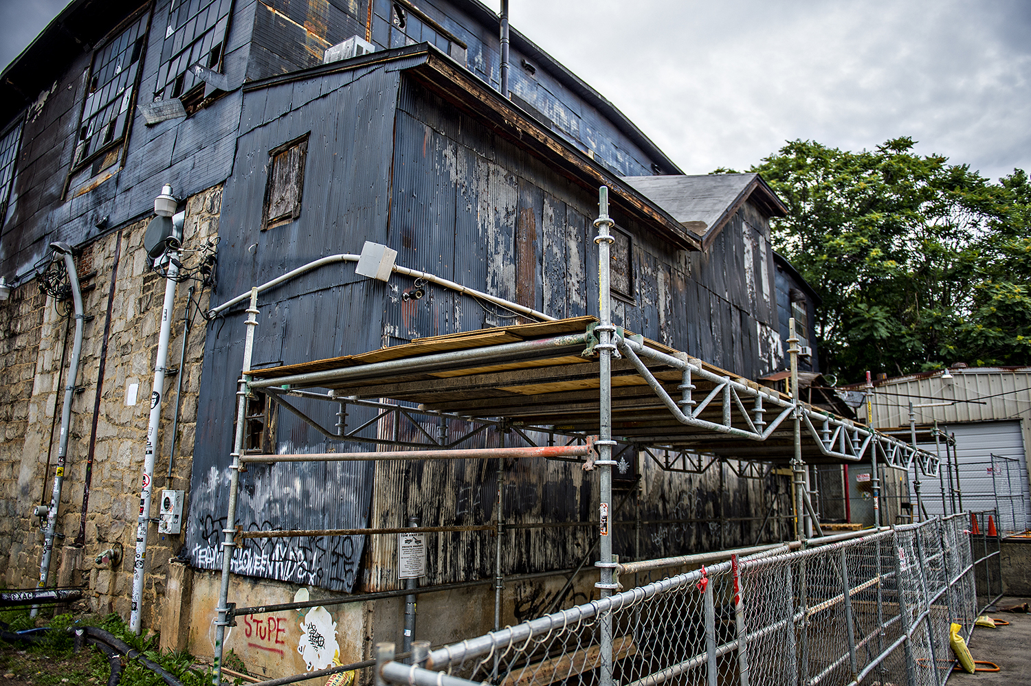 Scaffolding and fencing have been set up around the outside of The Masquerade off North Angier Avenue. This historically protected segment will house mixed uses near the large green field of Historic Fourth Ward Park's north end.  