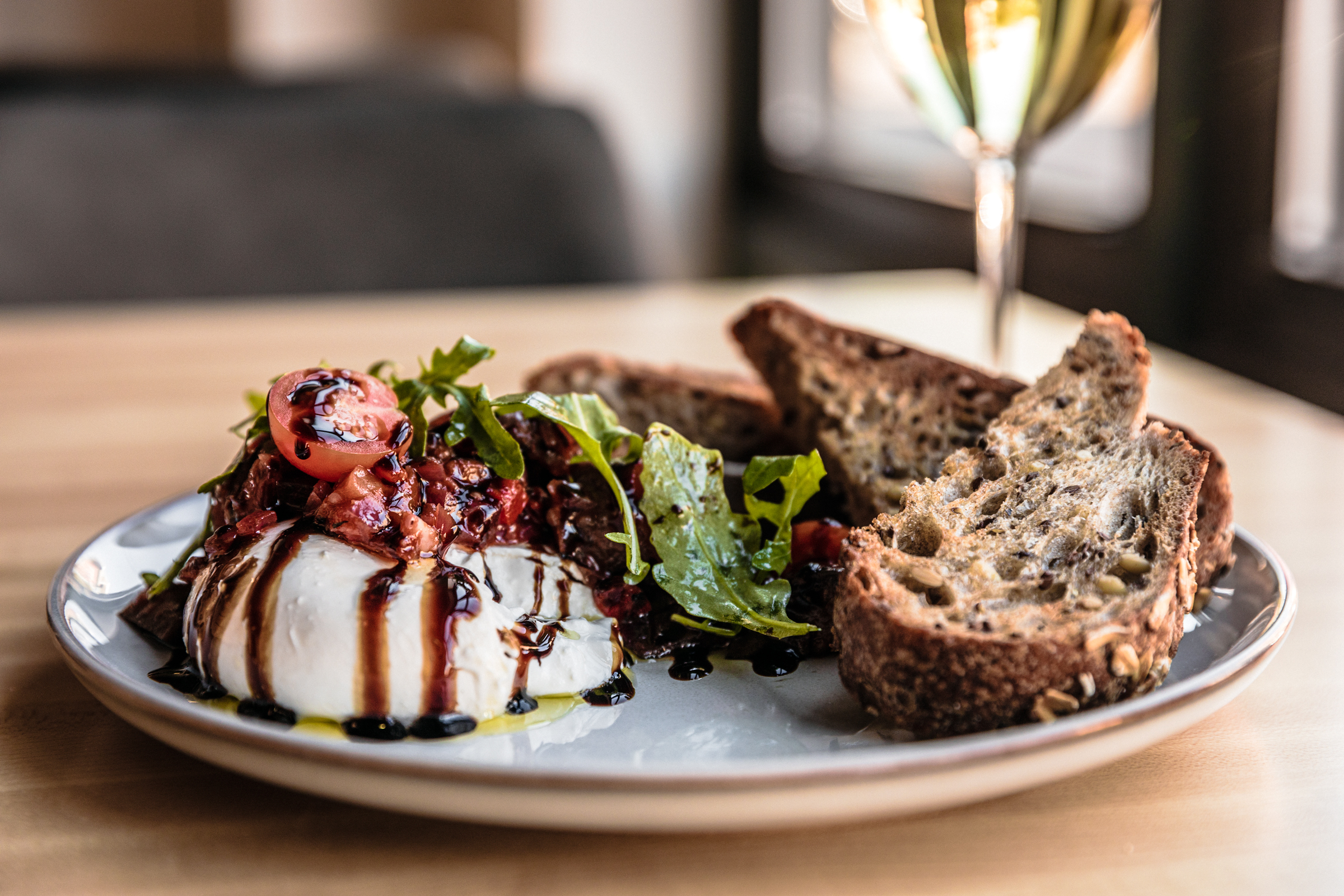 A plate of burrata and toast.