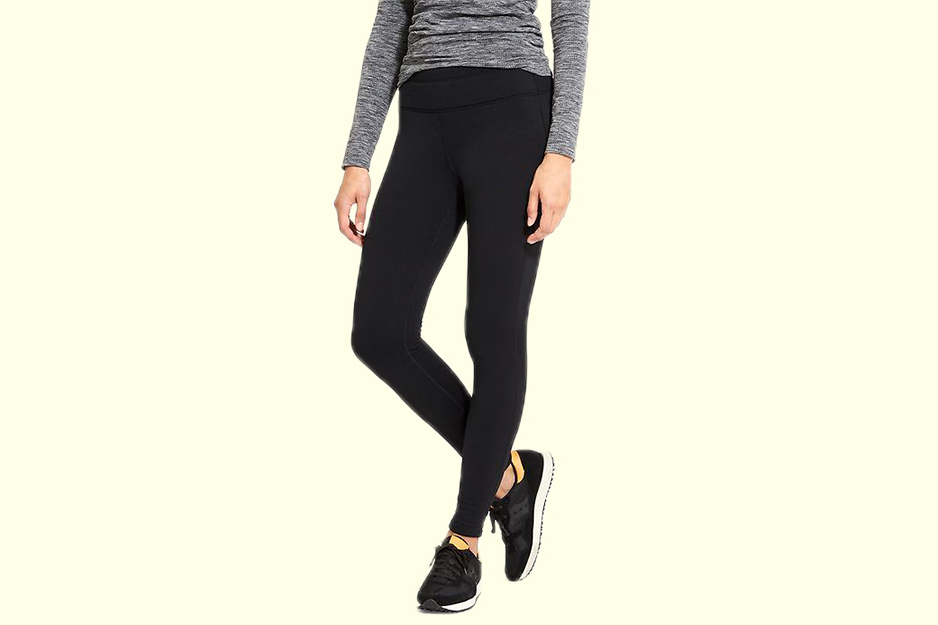 A model wearing Athleta’s Fleece-Lined Leggings in black with a gray shirt