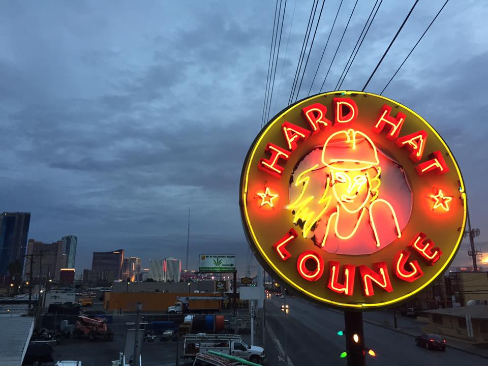 A neon sign for the Hard Hat Lounge