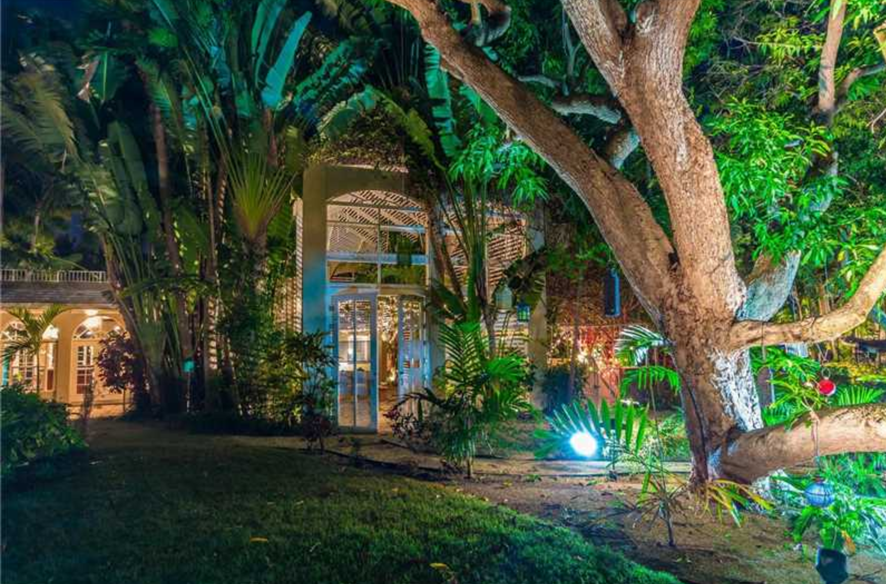 A charming vintage home in Miami Beach with lush landscaping and a ton of canal frontage