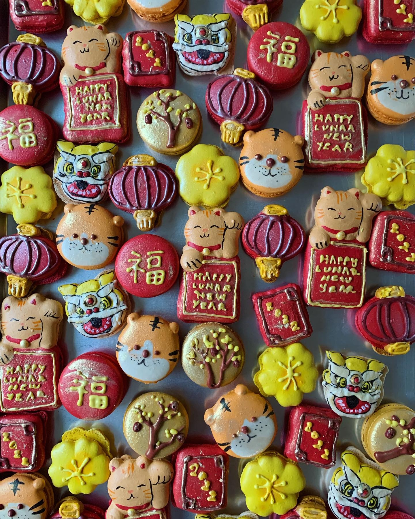 Cookies in the shape of tiger faces, dragon faces, and lanterns.