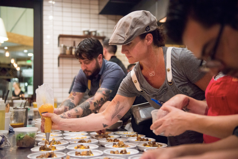 Chefs Brett Cooper and Brooke Mosley plating during Indie Chefs Week in 2014