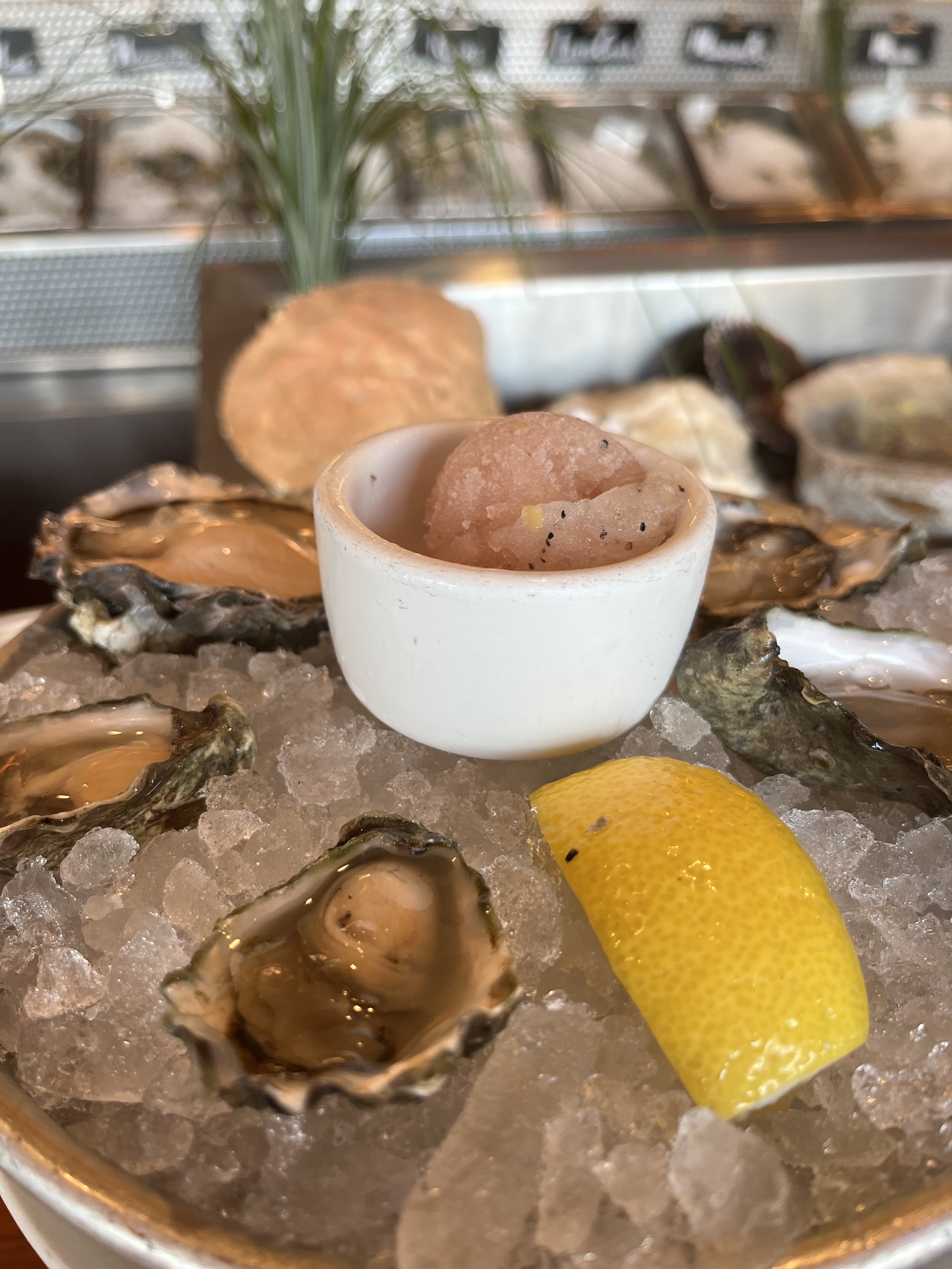 A tray of oysters on the half shell with frozen mignonette.