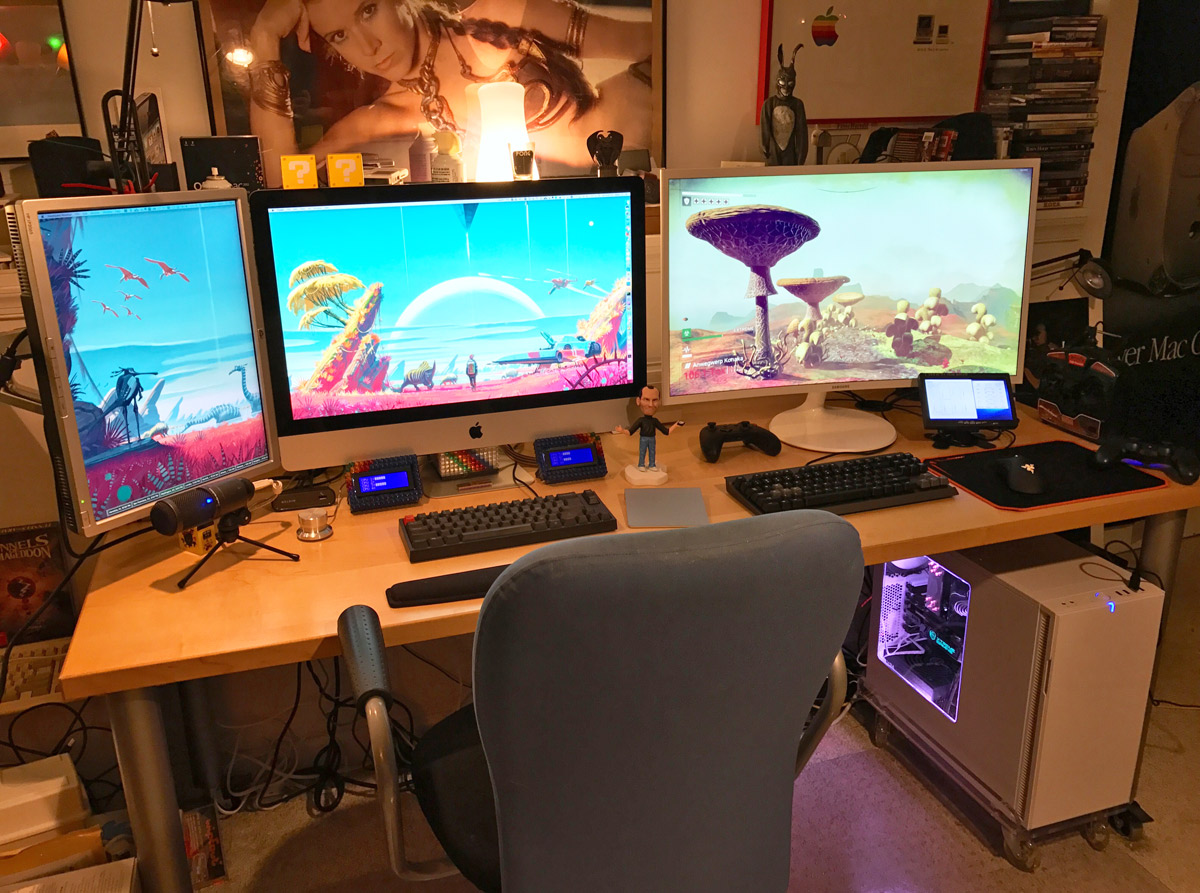 three monitors on a desk