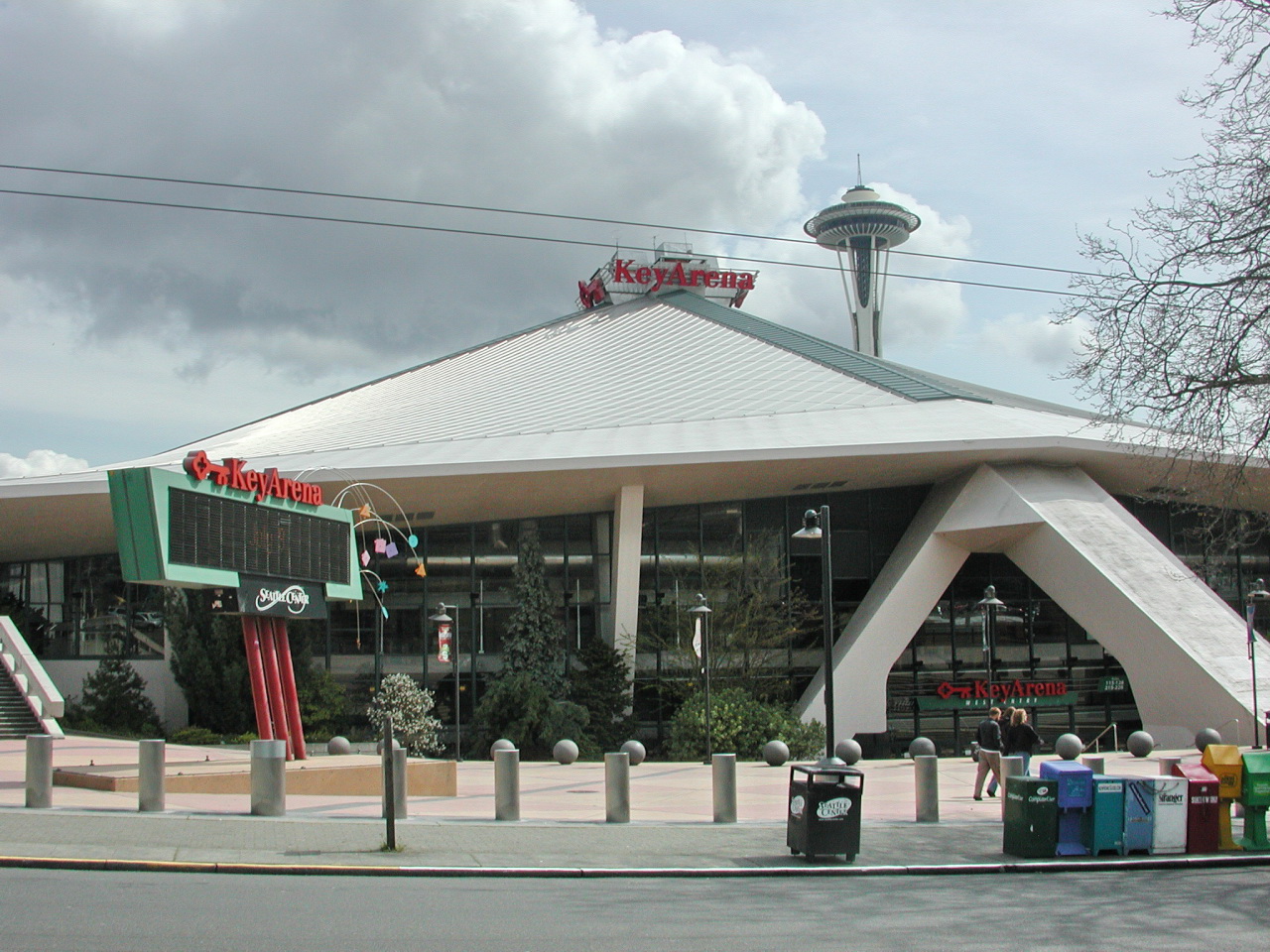 KeyArena on a cloudy day with the Space Needle in the background