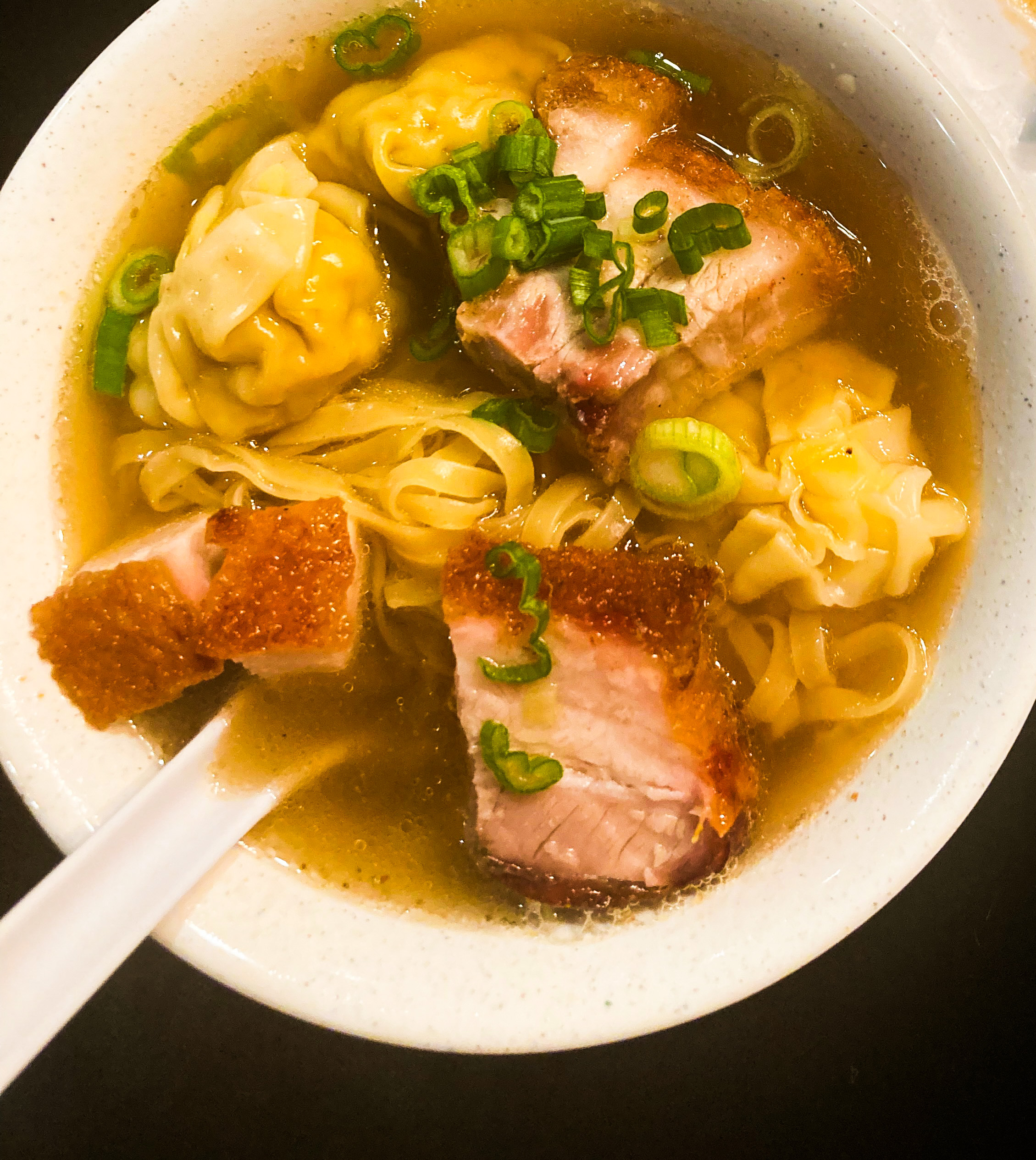 Pieces of pork float among egg noodles and wontons in a bowl of soup from Fortune BBQ Noodle House in Portland.