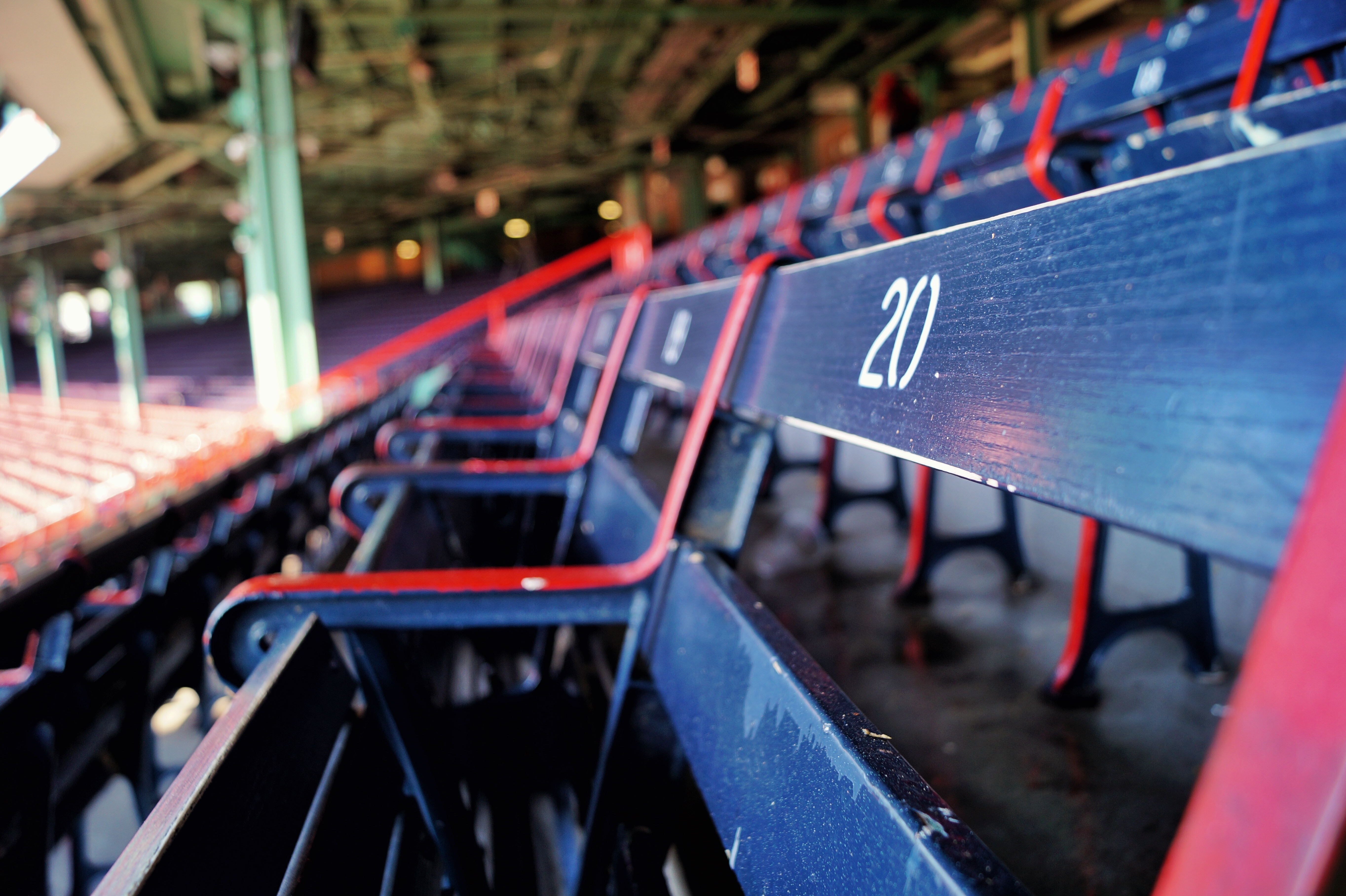 A row of wooden seats in an open-air ballpark. 