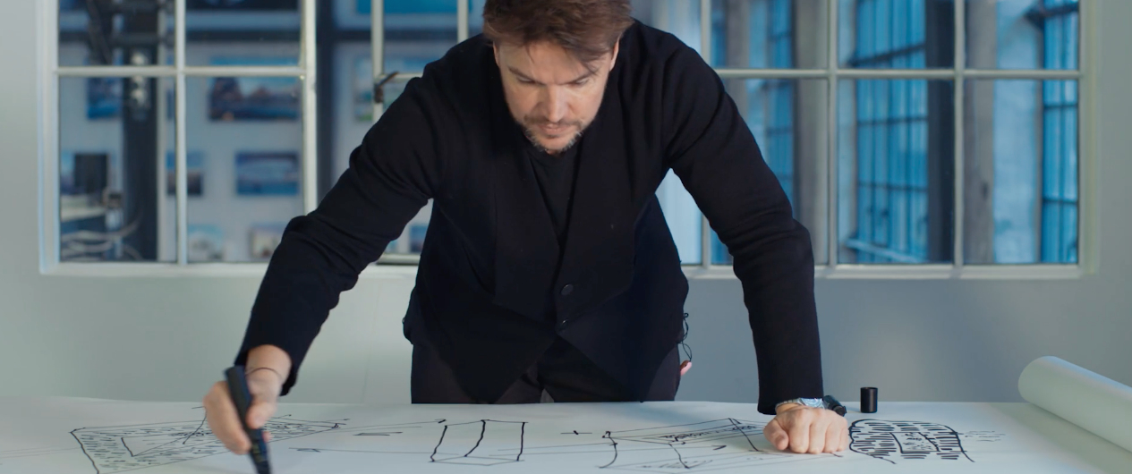 architect Bjarke Ingels hovering over a sketch